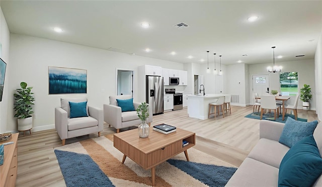 656 Marion Oaks Mnr, Ocala, FL 34473 - living area featuring light wood-style floors, recessed lighting, and a chandelier