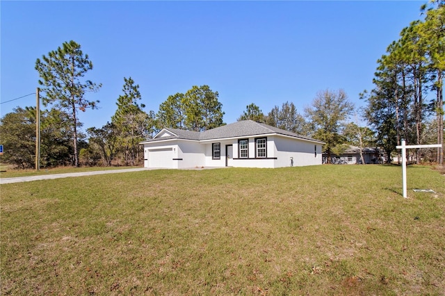 view of front of house featuring concrete driveway, a front lawn, an attached garage, and stucco siding