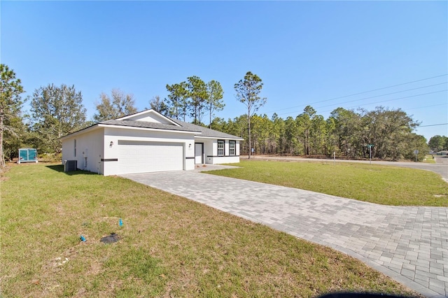 ranch-style house featuring a front yard, decorative driveway, an attached garage, and stucco siding