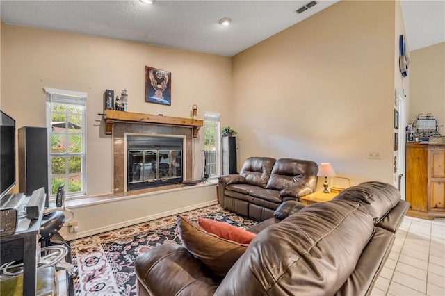 tiled living room with a tile fireplace