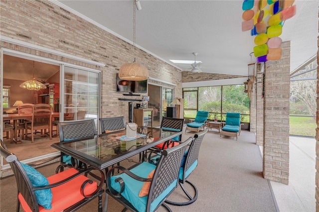 view of patio featuring ceiling fan and glass enclosure