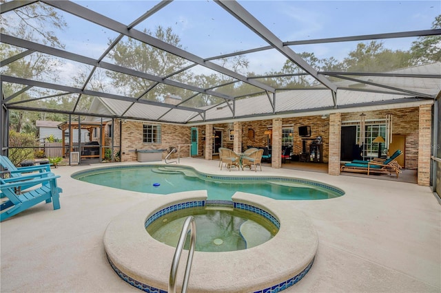 view of swimming pool with an in ground hot tub, glass enclosure, a patio area, and a pergola