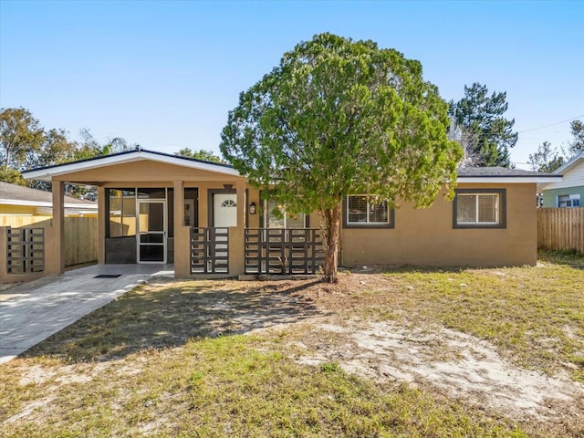 back of property featuring fence and stucco siding