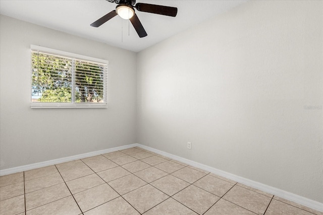 unfurnished room with light tile patterned floors, a ceiling fan, and baseboards