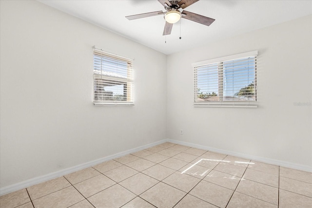 unfurnished room featuring baseboards, a ceiling fan, and light tile patterned flooring