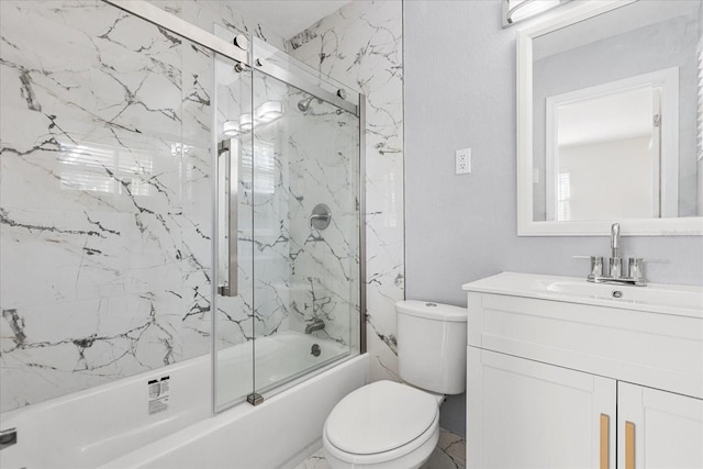 bathroom featuring marble finish floor, vanity, toilet, and bath / shower combo with glass door