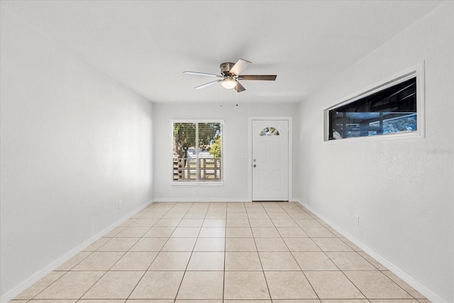 entrance foyer with light tile patterned floors, ceiling fan, and baseboards