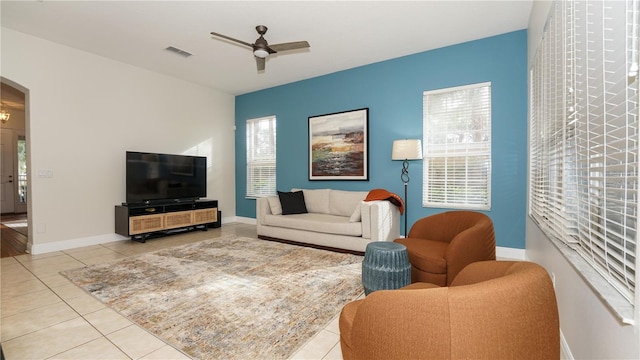 tiled living room featuring ceiling fan