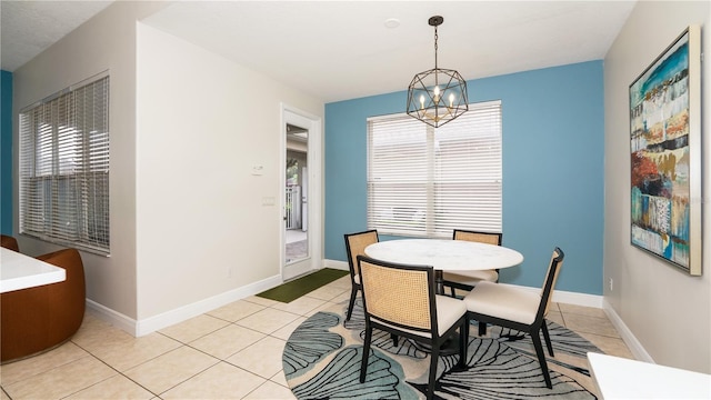 dining room featuring light tile patterned floors, a chandelier, and a healthy amount of sunlight