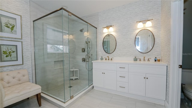 bathroom featuring vanity, toilet, and a shower with door