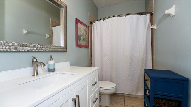 bathroom featuring tile patterned floors, toilet, and vanity