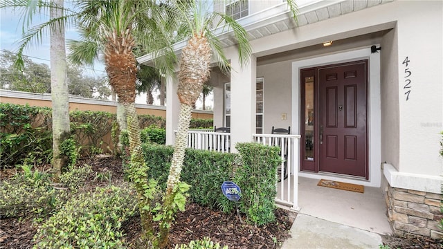 doorway to property featuring covered porch