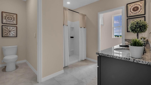 bathroom with tile patterned floors, toilet, vanity, and walk in shower