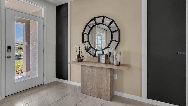 foyer with plenty of natural light and light tile patterned floors