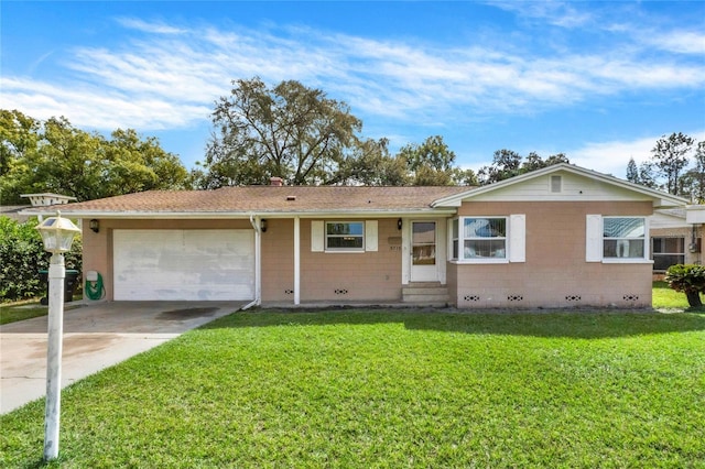 single story home featuring a front yard and a garage