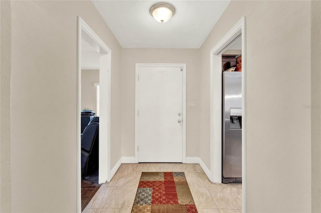 tiled entrance foyer featuring a textured ceiling