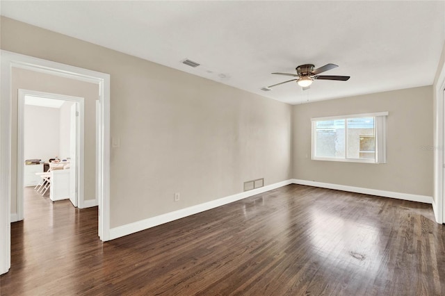 spare room featuring ceiling fan and dark hardwood / wood-style flooring