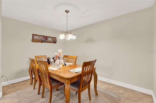 tiled dining area featuring an inviting chandelier