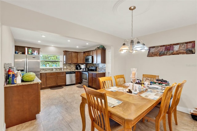 dining area with light tile patterned flooring and a chandelier