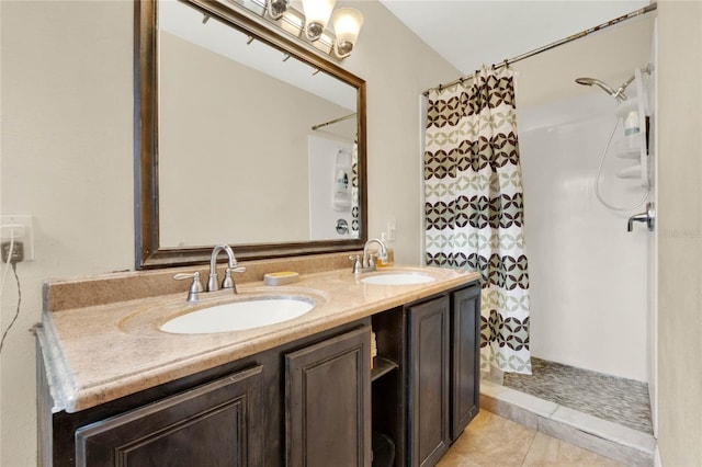 bathroom featuring tile patterned flooring, vanity, and curtained shower