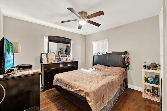 bedroom with dark hardwood / wood-style floors and ceiling fan