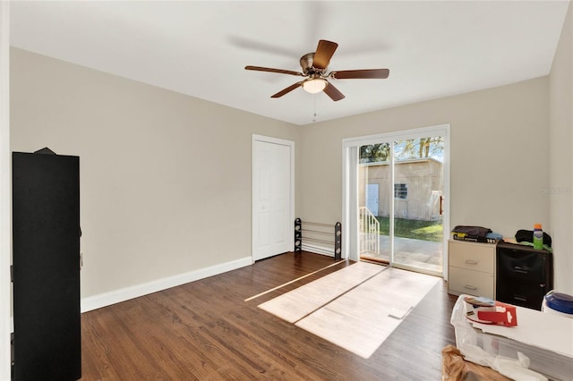 interior space featuring ceiling fan, access to outside, and dark hardwood / wood-style flooring