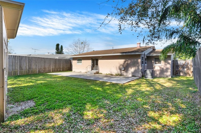 back of property with a patio area and a lawn