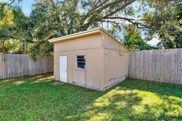 view of outbuilding with a lawn