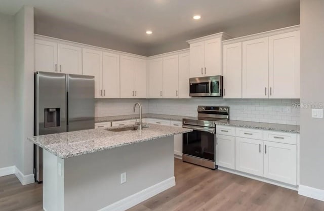 kitchen with appliances with stainless steel finishes, sink, and white cabinets