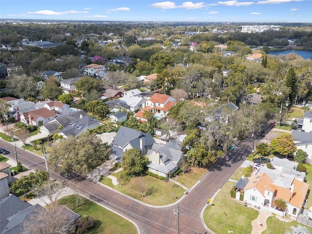 drone / aerial view with a water view and a residential view