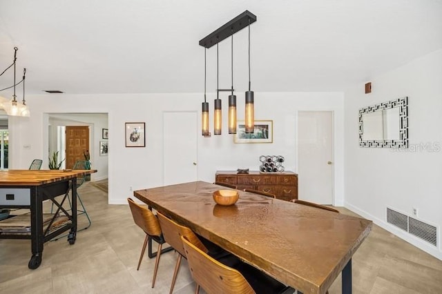 dining space featuring baseboards and visible vents