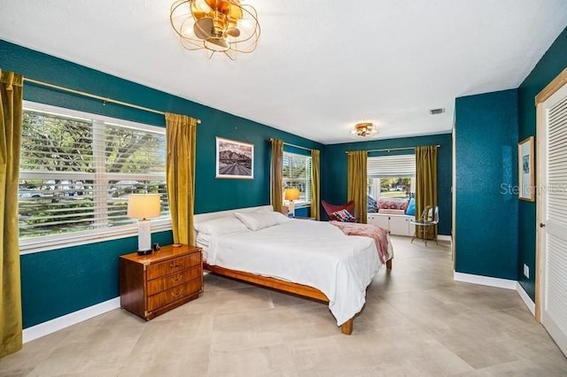 bedroom featuring visible vents, baseboards, and a closet