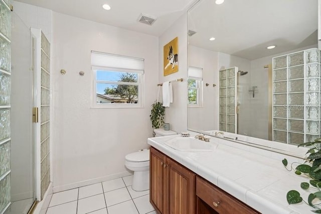 bathroom featuring visible vents, tiled shower, toilet, and vanity