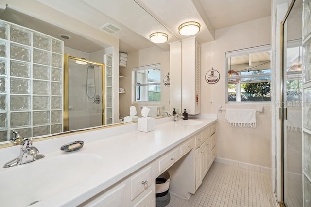 full bathroom featuring visible vents, double vanity, a stall shower, a sink, and tile patterned floors