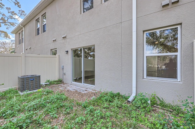 1209 S Station Pl Unit 306, Orlando, FL 32809 - rear view of property with fence, central AC, and stucco siding