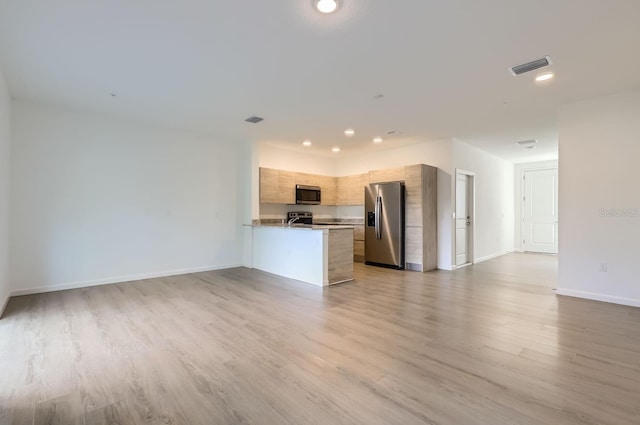 1209 S Station Pl Unit 306, Orlando, FL 32809 - kitchen featuring light brown cabinets, stainless steel appliances, visible vents, open floor plan, and modern cabinets