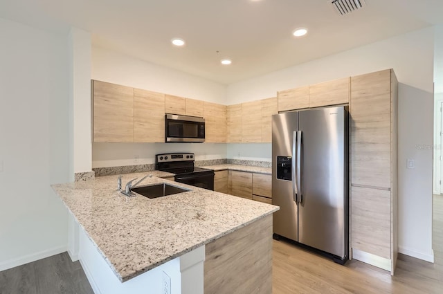 1209 S Station Pl Unit 306, Orlando, FL 32809 - kitchen featuring appliances with stainless steel finishes, visible vents, light stone counters, and light brown cabinetry