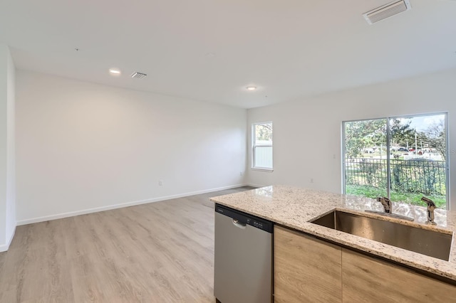 1209 S Station Pl Unit 306, Orlando, FL 32809 - kitchen featuring visible vents, a sink, stainless steel dishwasher, and light stone countertops