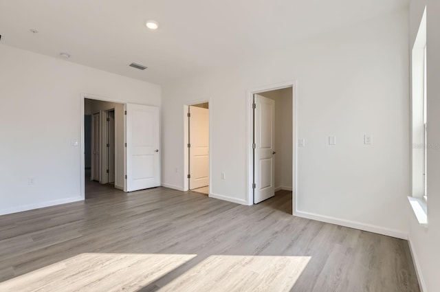 1209 S Station Pl Unit 306, Orlando, FL 32809 - unfurnished bedroom with baseboards, visible vents, and light wood finished floors