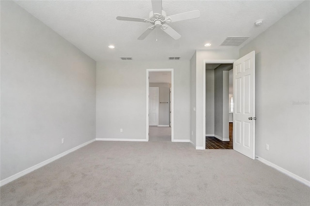 unfurnished bedroom featuring light carpet, visible vents, and baseboards