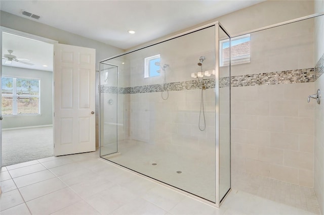 bathroom featuring tile patterned flooring, a shower stall, visible vents, and a healthy amount of sunlight