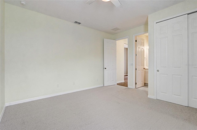 unfurnished bedroom with light carpet, visible vents, and baseboards