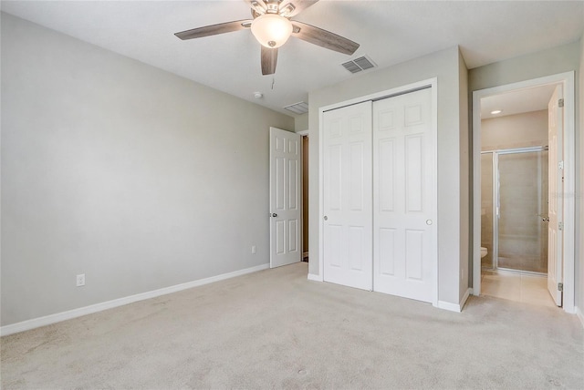 unfurnished bedroom featuring light carpet, baseboards, visible vents, ensuite bath, and a closet