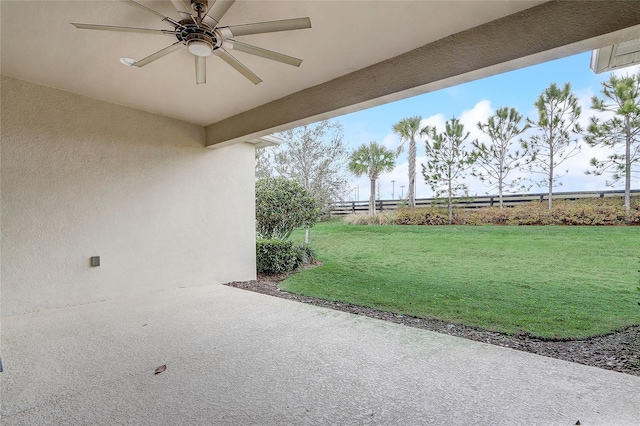 view of patio featuring fence and a ceiling fan