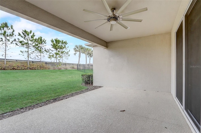 view of patio / terrace with fence and a ceiling fan