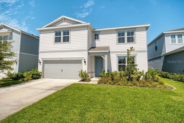 traditional home with concrete driveway, a garage, and a front yard