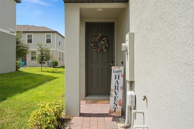 2052 Milkweed St, Ocoee, FL 34761 - property entrance featuring stucco siding, central AC, and a lawn