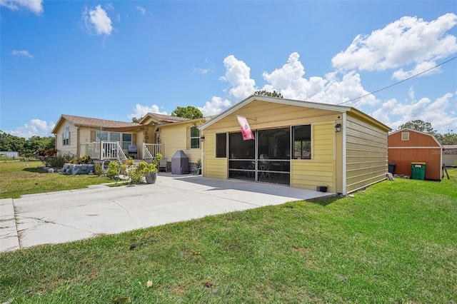 back of property featuring covered porch and a yard