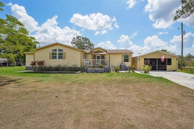 single story home featuring covered porch and a front yard