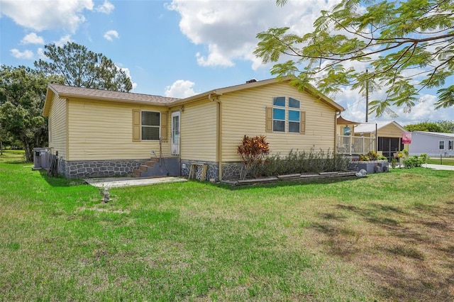 back of house with a yard